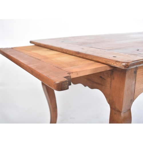 125 - A late 19th century French continental fruitwood refectory farmhouse dining table. The table having ... 