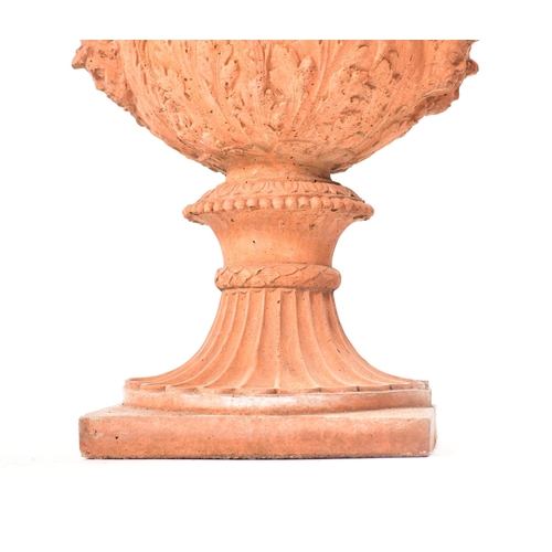 13 - A pair of 20th century circa 1930s Neo Classical style terracotta urn planters. Each having a gadroo... 