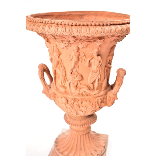 13 - A pair of 20th century circa 1930s Neo Classical style terracotta urn planters. Each having a gadroo... 