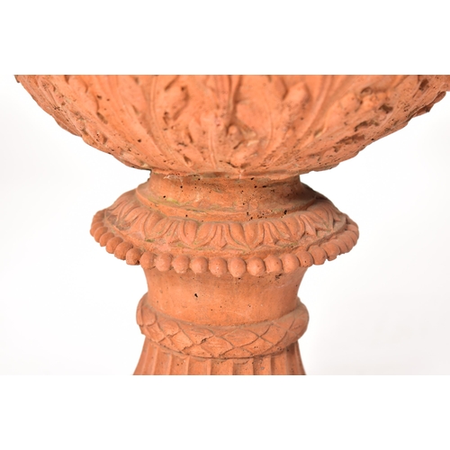 13 - A pair of 20th century circa 1930s Neo Classical style terracotta urn planters. Each having a gadroo... 