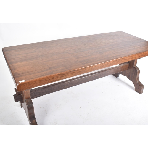 130 - A 20th century Victorian manner solid oak country refectory trestle dining table. The table having a... 