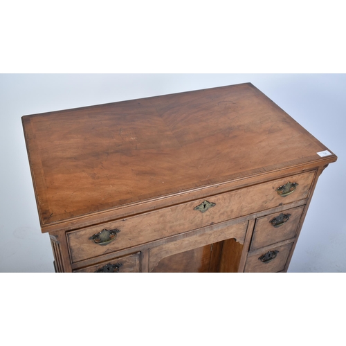 135 - A late 18th century Queen Anne revival walnut kneehole desk. Raised on bracket feet with drawers to ... 