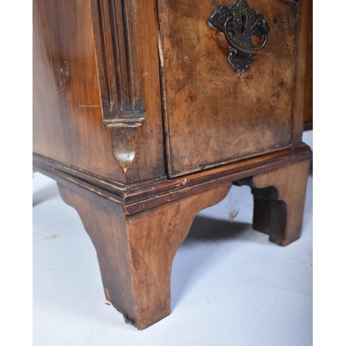 135 - A late 18th century Queen Anne revival walnut kneehole desk. Raised on bracket feet with drawers to ... 