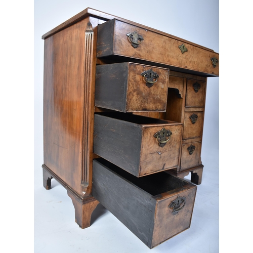 135 - A late 18th century Queen Anne revival walnut kneehole desk. Raised on bracket feet with drawers to ... 