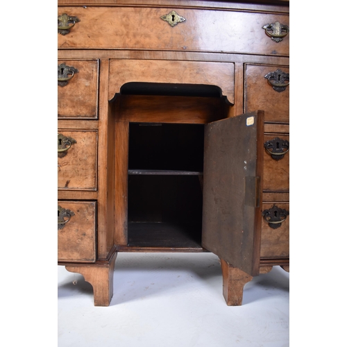 135 - A late 18th century Queen Anne revival walnut kneehole desk. Raised on bracket feet with drawers to ... 