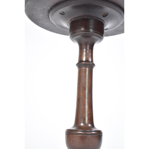 146 - A mahogany pedestal wine table of small proportions. The splayed legs with hoof feet on pads having ... 