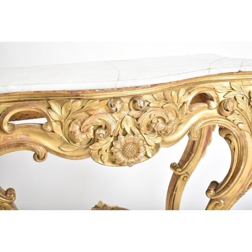 150 - A 19th century Rococo style gilt wood & marble top console hall table. The table having a serpentine... 