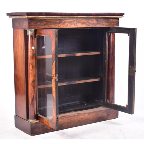 154 - A 19th century French Empire manner rosewood glazed bookcase cabinet. The cabinet having a straight ... 