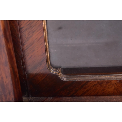 154 - A 19th century French Empire manner rosewood glazed bookcase cabinet. The cabinet having a straight ... 