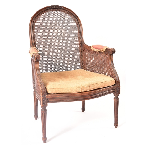 158 - A pair of 19th century French walnut bergere armchairs. The twin caned fauteuils being raised on tur... 