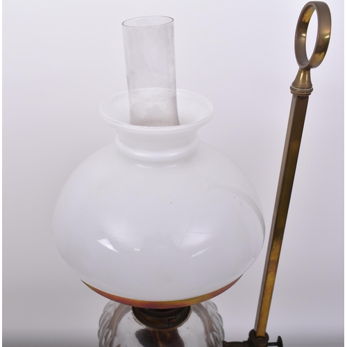 163 - An Art Nouveau early 20th century circa 1900s brass & glass desk oil lamp light. The lamp having a b... 