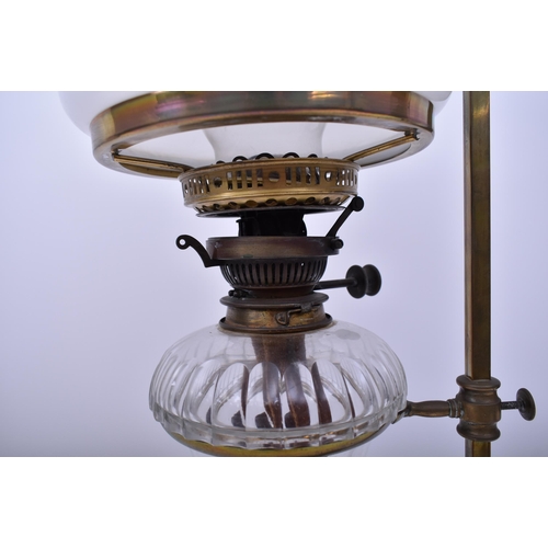 163 - An Art Nouveau early 20th century circa 1900s brass & glass desk oil lamp light. The lamp having a b... 