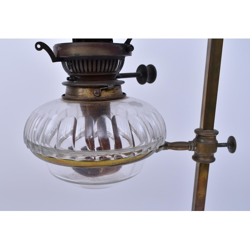 163 - An Art Nouveau early 20th century circa 1900s brass & glass desk oil lamp light. The lamp having a b... 