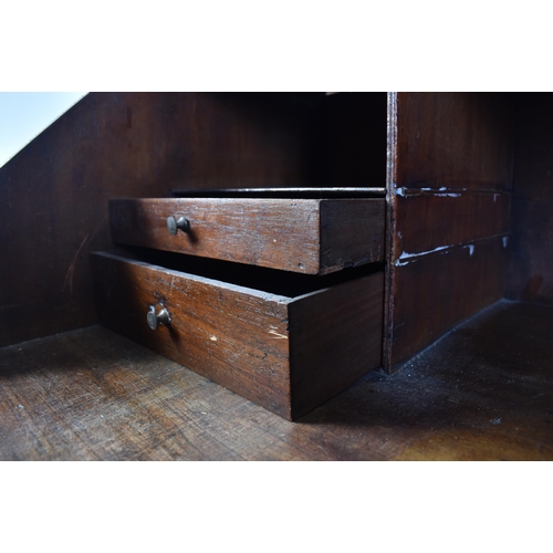 17 - A 19th century George III Cuban mahogany bureau desk. Raised on bracket feet with a series of drawer... 