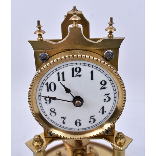 173 - A 19th century German Torsion Anniversary clock. The brass clock with swing pendulum raised on porti... 