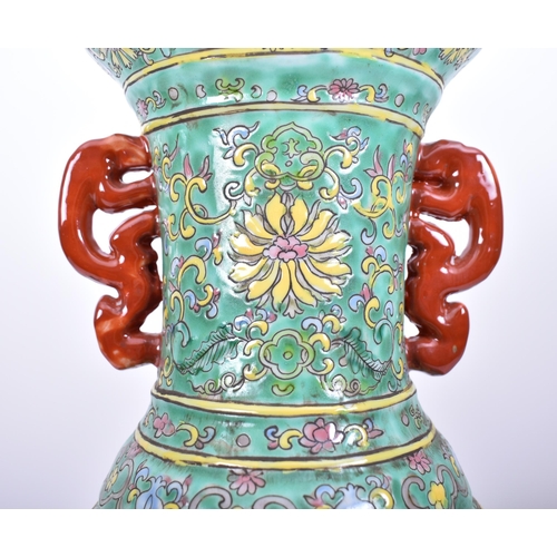 179 - A large 19th century Chinese famille rose green vase. The vase having a flared rim with elongated ne... 