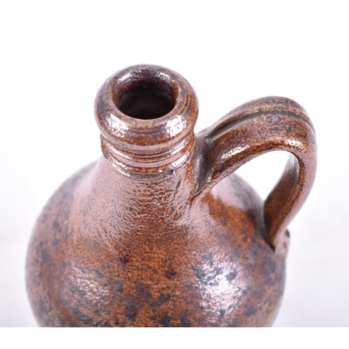 180 - A rare 17th century salt-glazed stoneware ale bottle / bellarmine jug in good condition with collect... 