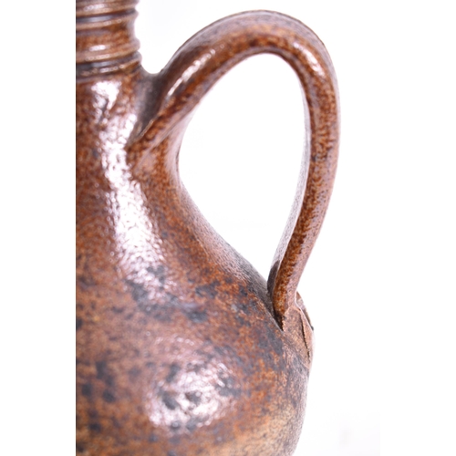 180 - A rare 17th century salt-glazed stoneware ale bottle / bellarmine jug in good condition with collect... 