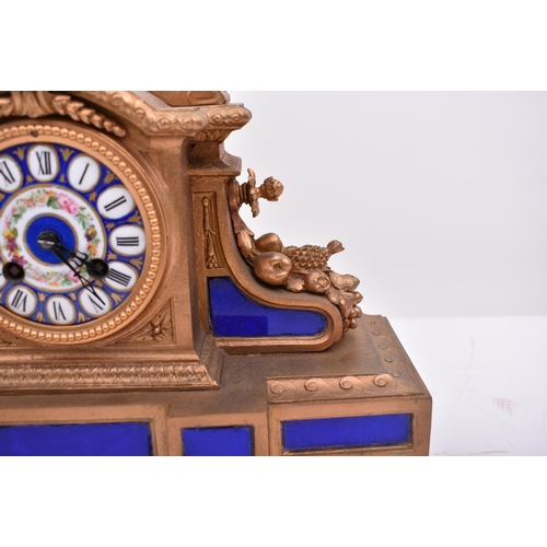 186 - A 19th century French gilt brass and enamel porcelain painted mantel clock. The clock inset with Sev... 