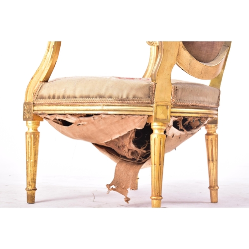 19 - A 19th century French giltwood elbow chair. The armchair having carved gilt frame with oval backrest... 