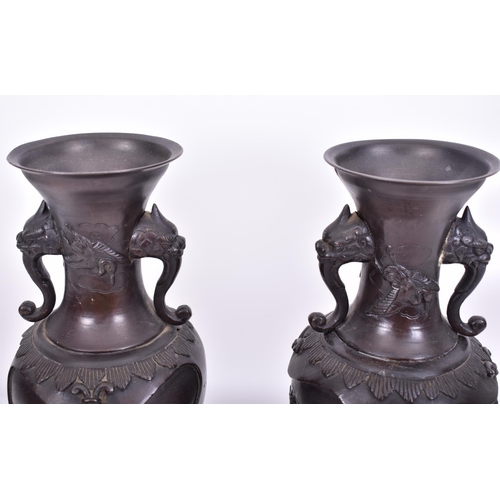 191 - A pair of 19th century Japanese hand cast bronze twin handled vases. Each having a flared rim over t... 