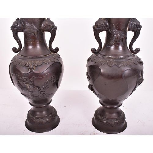 191 - A pair of 19th century Japanese hand cast bronze twin handled vases. Each having a flared rim over t... 