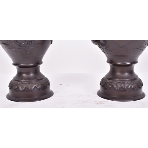 191 - A pair of 19th century Japanese hand cast bronze twin handled vases. Each having a flared rim over t... 