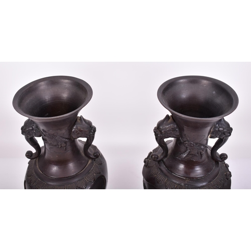 191 - A pair of 19th century Japanese hand cast bronze twin handled vases. Each having a flared rim over t... 