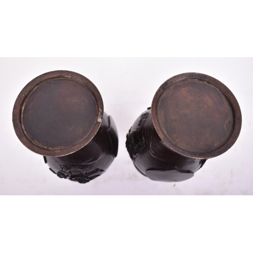 191 - A pair of 19th century Japanese hand cast bronze twin handled vases. Each having a flared rim over t... 