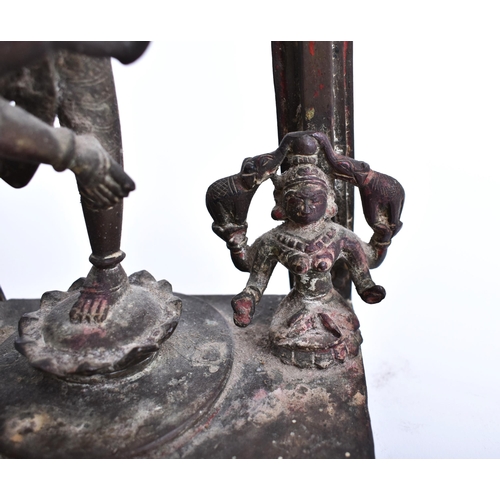 195 - A 19th century bronze altar temple sculpture depicting an Indian dancing deity. The god figure four ... 