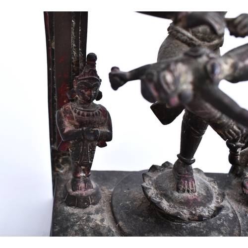 195 - A 19th century bronze altar temple sculpture depicting an Indian dancing deity. The god figure four ... 