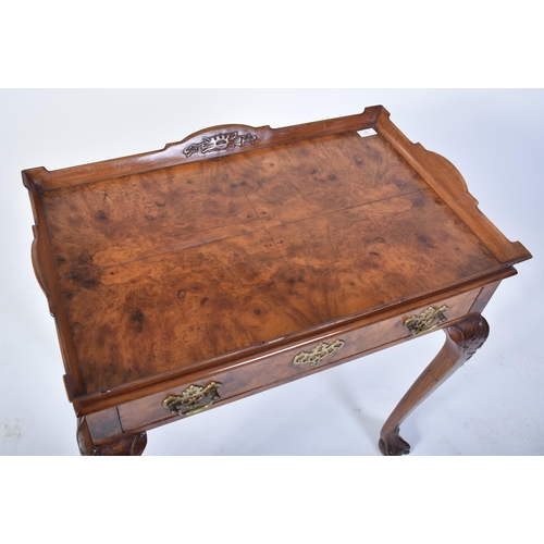 197 - A Queen Anne walnut revival silver table. Raised on cabriole legs with claw and ball feet having fit... 