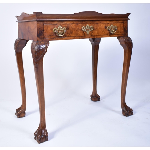 197 - A Queen Anne walnut revival silver table. Raised on cabriole legs with claw and ball feet having fit... 