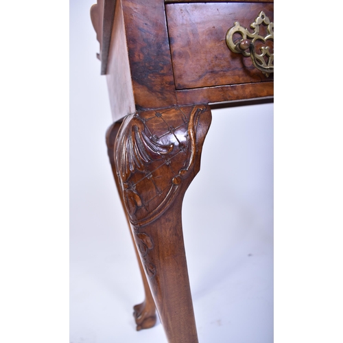 197 - A Queen Anne walnut revival silver table. Raised on cabriole legs with claw and ball feet having fit... 