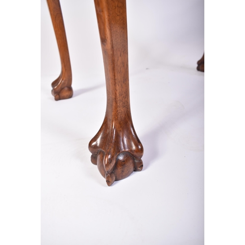 197 - A Queen Anne walnut revival silver table. Raised on cabriole legs with claw and ball feet having fit... 