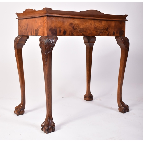 197 - A Queen Anne walnut revival silver table. Raised on cabriole legs with claw and ball feet having fit... 