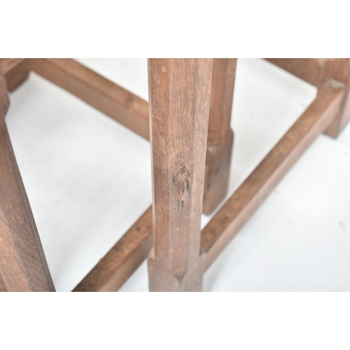 20 - Workshop of Robert Mouseman Thompson of Kilburn - an English solid carved oak nest of tables. Each t... 