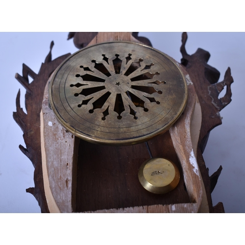 22 - A 19th century carved oak Black Forest wall clock. The clock with carved rococo body with cherub and... 