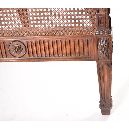 222 - An early 20th century carved walnut & wicker double bed frame. The frame having a hand carved one pi... 