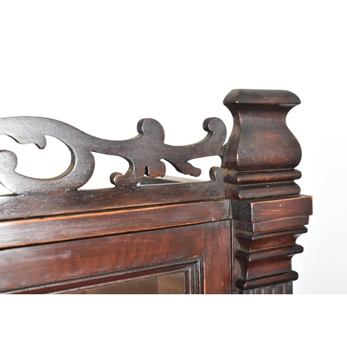 224 - A Victorian 19th century mahogany library bookcase cabinet. The bookcase having a pierced fret work ... 