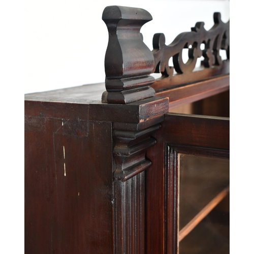 224 - A Victorian 19th century mahogany library bookcase cabinet. The bookcase having a pierced fret work ... 