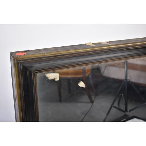 236 - A pair of 19th century Victorian mahogany and brass framed mirrors. Each mirror with deep cushioned ... 