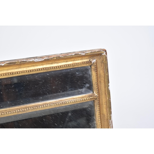 249 - A 19th century Regency gilt wood and gesso worked triptych overmantel mirror. The mirror with indivi... 