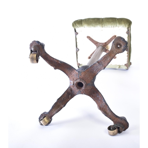 255 - A 19th century brass and cast iron cello stool. The stool having a low bar backrest with green butto... 