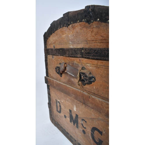 263 - A 19th century dome top wooden and metal bound steamer trunk. The wooden body with ebonised metal st... 