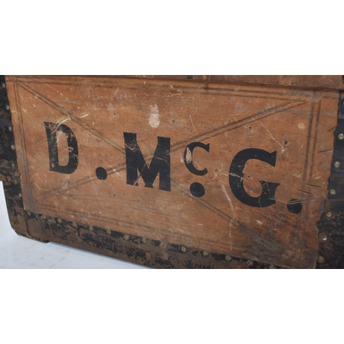 263 - A 19th century dome top wooden and metal bound steamer trunk. The wooden body with ebonised metal st... 