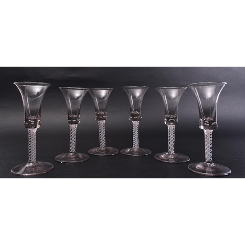 273 - A set of six matched mid - late 18th century George III opaque twist wine glasses. Each with taperin... 