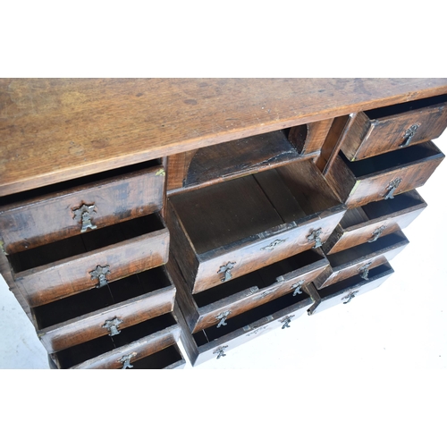 280 - A Queen Anne 18th century walnut chest on stand. The chest having a straight top over a central pige... 