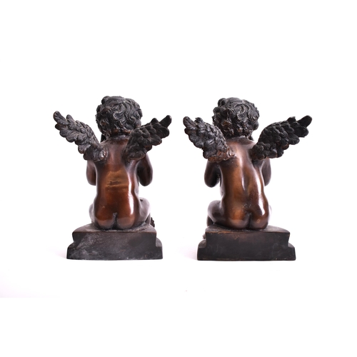 293 - A pair of early 20th century bronze cherub sculptures. Each of the cherubs seated on plinth base, wi... 