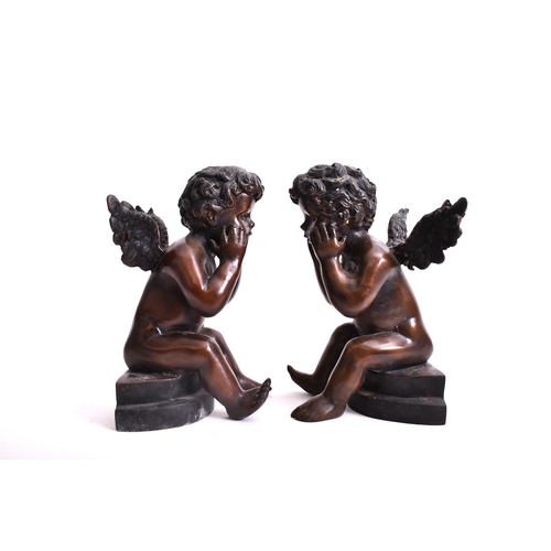 293 - A pair of early 20th century bronze cherub sculptures. Each of the cherubs seated on plinth base, wi... 